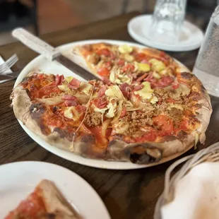 a whole pizza on a plate