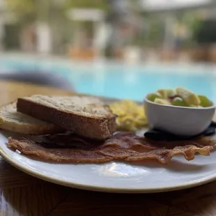 a plate of food on a table near a pool
