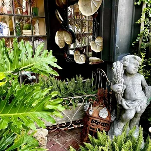 a garden with a statue of an angel