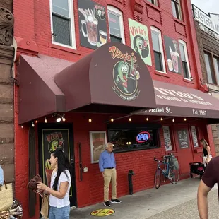 people standing outside of a restaurant