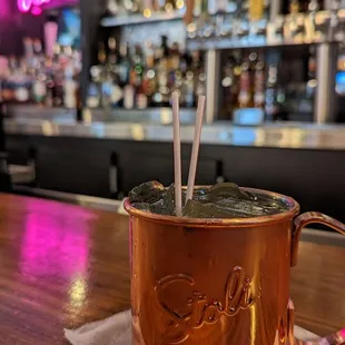 a copper mug with a straw sticking out of it