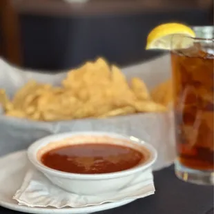 a plate of chips and a bowl of salsa