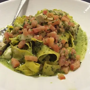 Pappardelle-cut pasta with pesto, pine nuts, tomatoes...and I added chicken. Delicious!