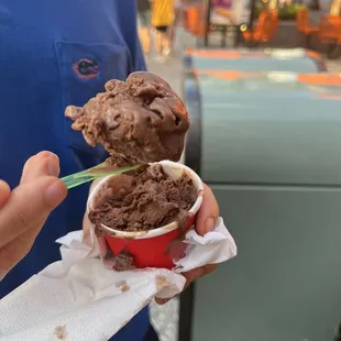 a person holding a cup of ice cream