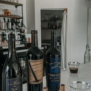 bottles of wine on a marble countertop