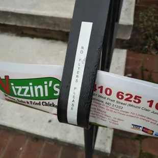 Vizzini's flyer under "No flyers please" sign.