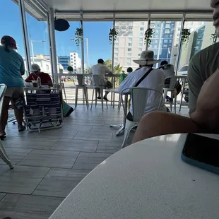 a man sitting at a table in a cafe
