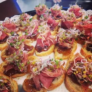 Prosciutto di Parma, Fig Compote, and Radish Sprout Crostini.