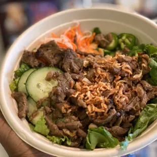 a person holding a bowl of food
