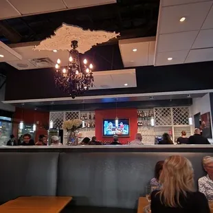 people sitting at tables in a restaurant