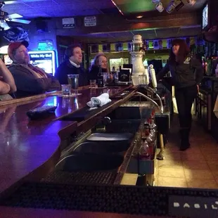 a group of people sitting at a bar