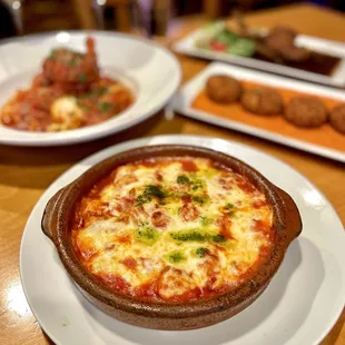 Gnocchi Sorrentina: Homemade potato gnocchi, plum tomato sauce, mozzarella and baked in a terracotta bowl with basil.