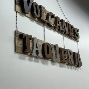 a sign hanging on a wall