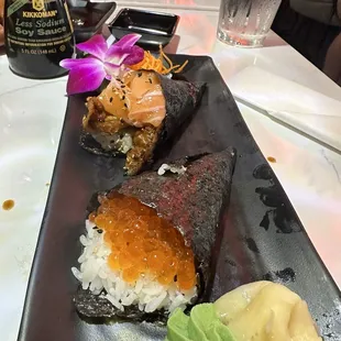 salmon and eel hand roll and salmon roe hand roll.