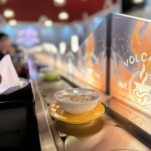 a hot pot of food on a conveyor belt
