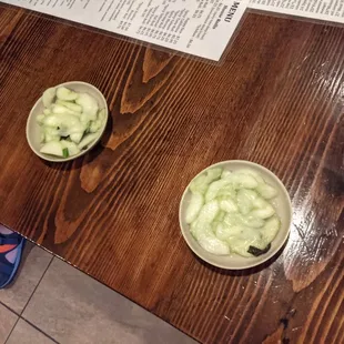 neat free appetizer of cucumbers in a sauce