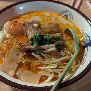 Spicy Tonkotsu Ramen,  White creamy shoyu broth, pork belly, scallion, corn bean sprouts ,bamboo shoot, kimchi with marinated soft egg.