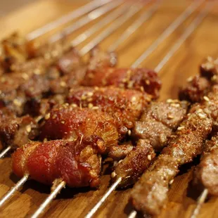 a variety of meats on skewers