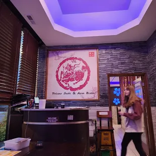 a woman walking through a restaurant