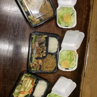 Two steak and chicken meals with rice, noodles and veggies. One vegetable meal with the same. Salads with ginger dressing.