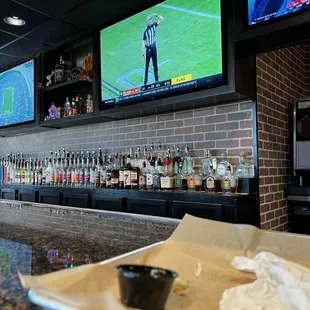 The well stocked bar and wall of tv monitors at Volkerts