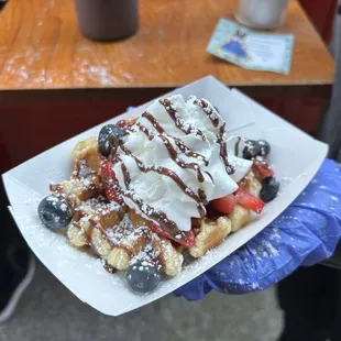 Waffle with strawberries, blueberries, and other toppings