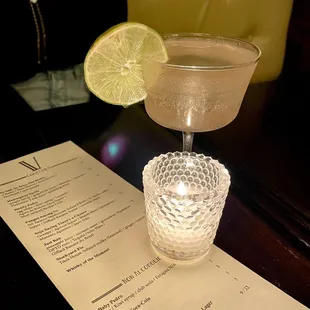 a glass of lemonade with a slice of lime