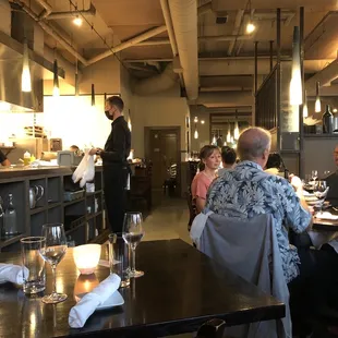 a man standing in the middle of a restaurant