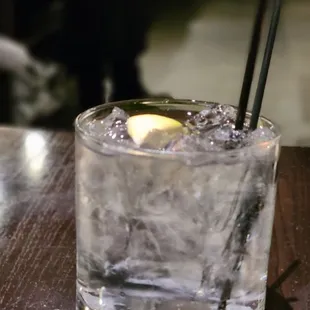 a glass of water with a lemon wedge in it