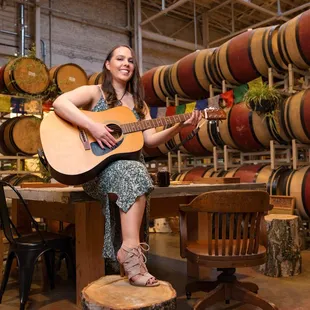 a woman playing a guitar