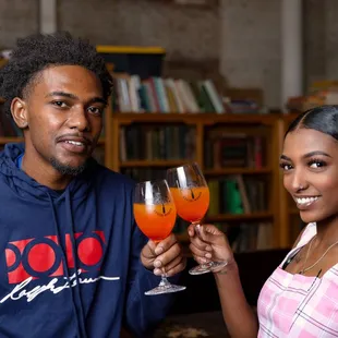 a man and woman holding wine glasses