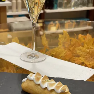 a pastry and a glass of wine