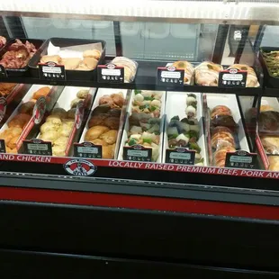 a variety of meats in a display case