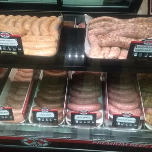 a variety of sausages in a display case
