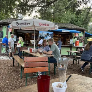 a group of people sitting at picnic tables