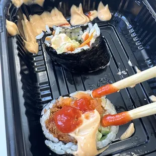 Shrimp, tempura, sushi, ready, and prepared to go in a deli case