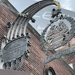 a brick building with a sign and a clock