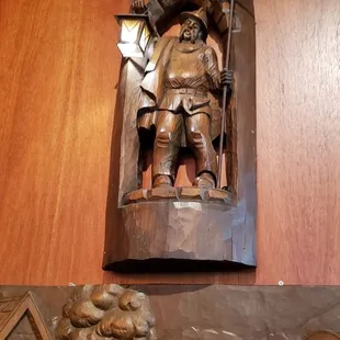 a wooden relief of a man on a horse