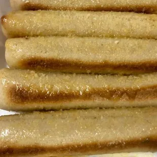 four hot dogs in a paper container