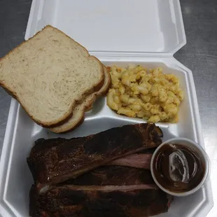 a tray of meat and macaroni and cheese