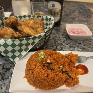 My order of Kimchi fried rice, basket of Honey Butter Fried Chicken (half order) and a side of pickled cucumber.
