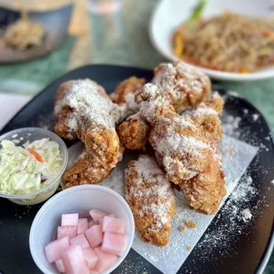 a plate of fried chicken with a side of coleslaw