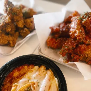 a plate of wings and a bowl of sauce