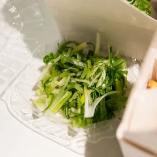 Shredded green onions for the Crispy Padak Chicken