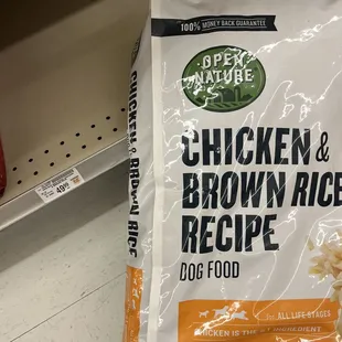 a person holding a bag of chicken and brown rice