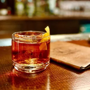 a drink in a glass on a bar table