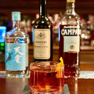 a glass of alcohol and a bottle of liquor