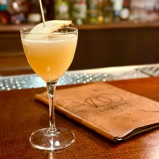 a cocktail in a glass on a bar