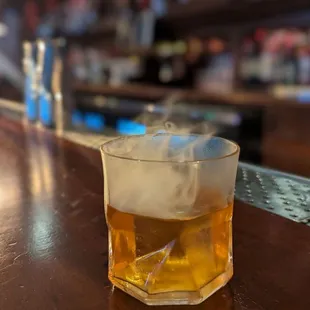 a glass of alcohol on a bar