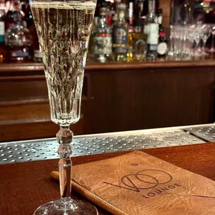 a glass of champagne on a bar
